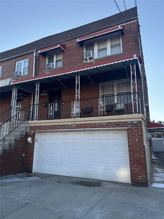 multi unit property with driveway, brick siding, and cooling unit