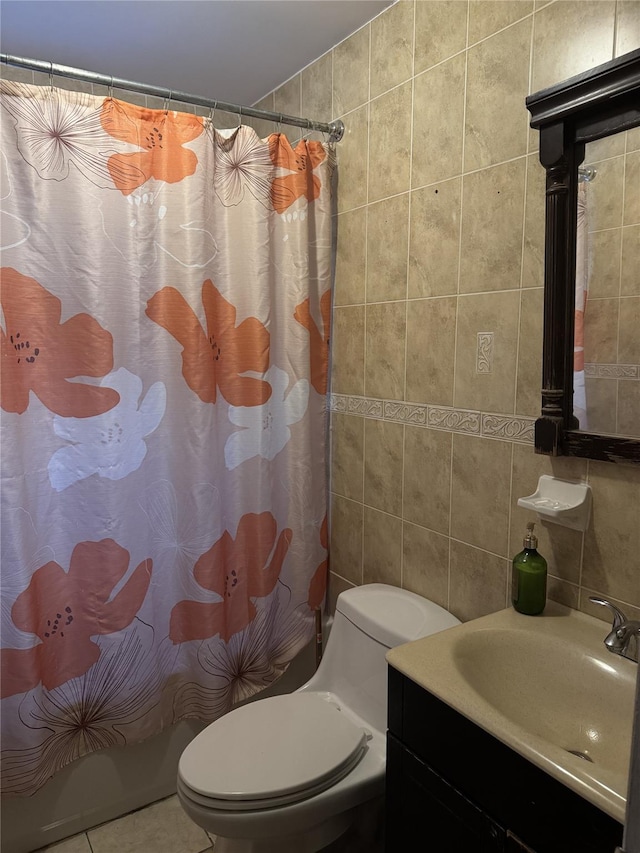 bathroom with toilet, tile patterned flooring, backsplash, and tile walls