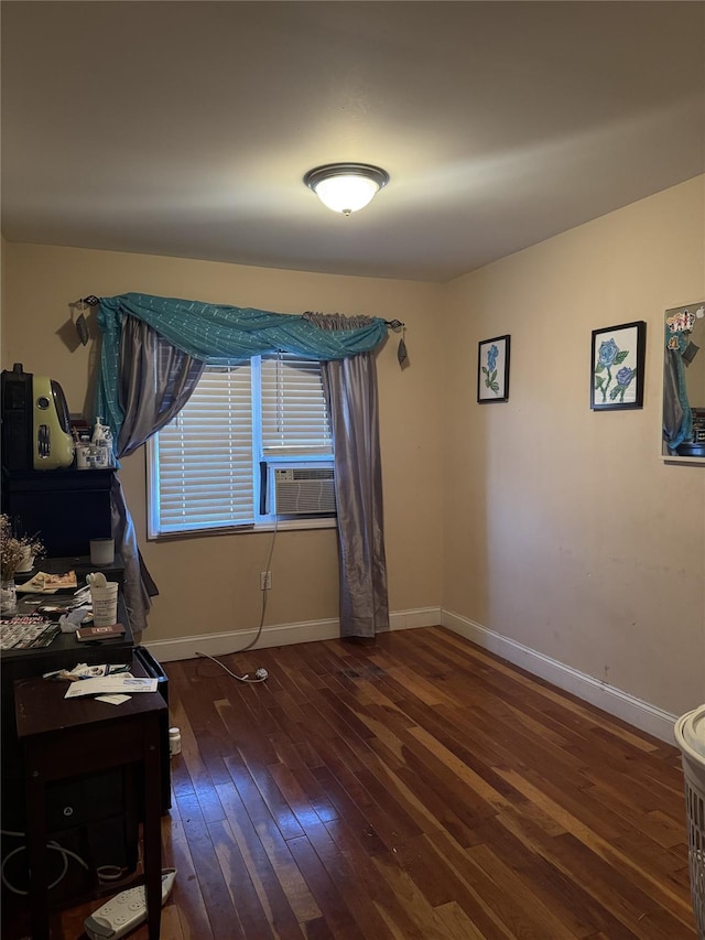 interior space featuring cooling unit, baseboards, and hardwood / wood-style flooring