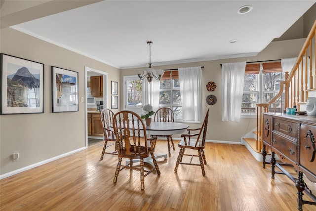 dining space with stairway, baseboards, light wood-style floors, crown molding, and a chandelier