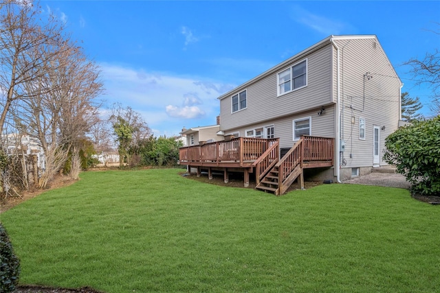 rear view of house with a lawn and a wooden deck