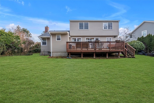 rear view of house featuring a wooden deck, a lawn, and a chimney