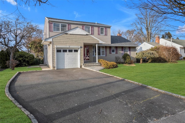 traditional-style home with aphalt driveway, a garage, and a front lawn