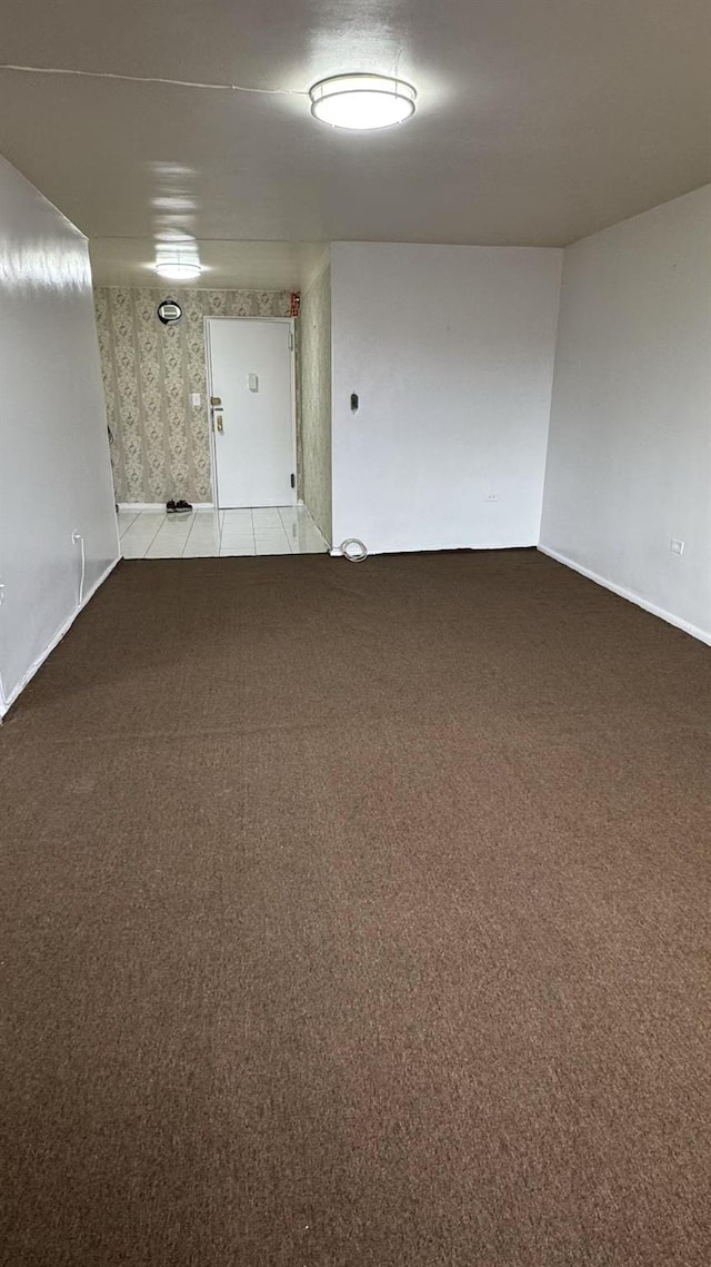 unfurnished room with light carpet and wallpapered walls