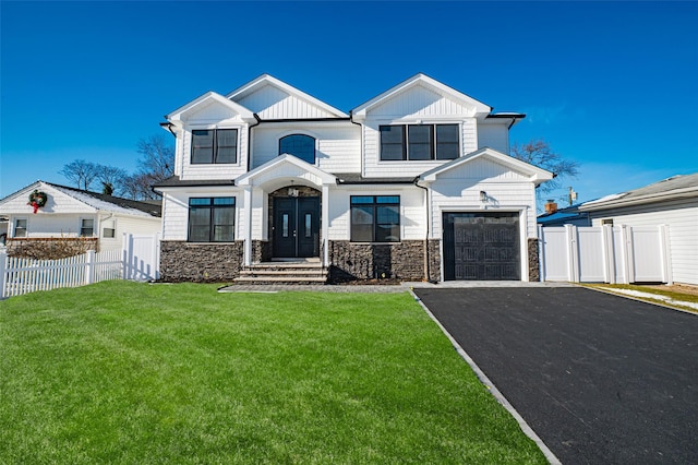 modern farmhouse featuring driveway, a garage, fence, and a front yard