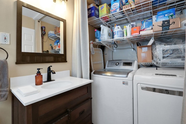 laundry area with laundry area, independent washer and dryer, and a sink