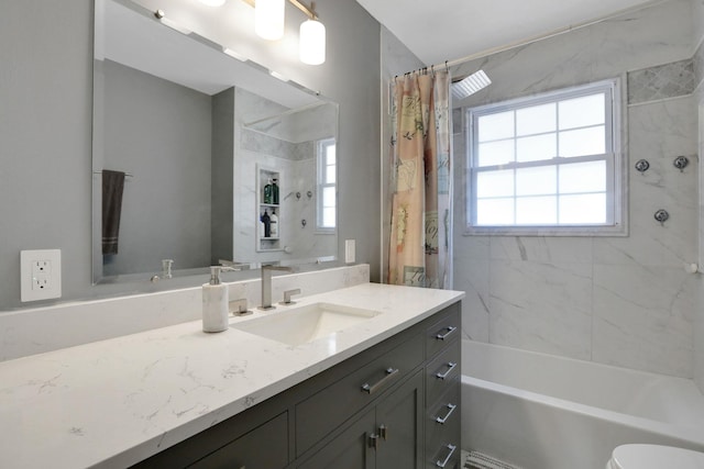 full bath featuring a wealth of natural light, shower / tub combo with curtain, vanity, and toilet