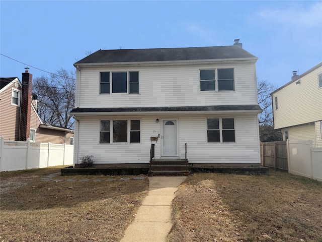 view of front of house featuring a chimney and a fenced backyard