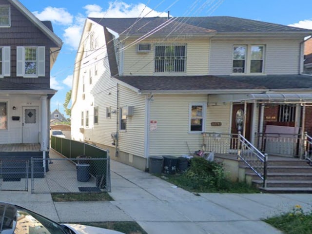 view of front of property featuring driveway and a shingled roof