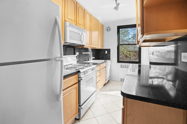 kitchen with light brown cabinets, backsplash, radiator heating unit, white appliances, and light tile patterned floors