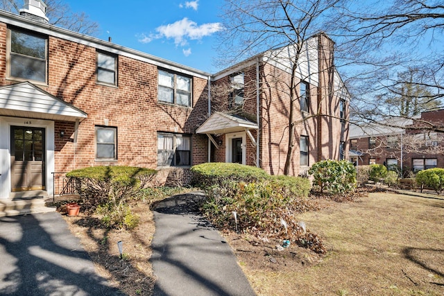 view of property with brick siding