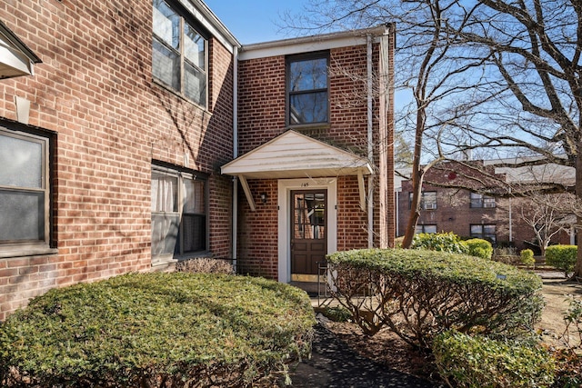 view of exterior entry with brick siding