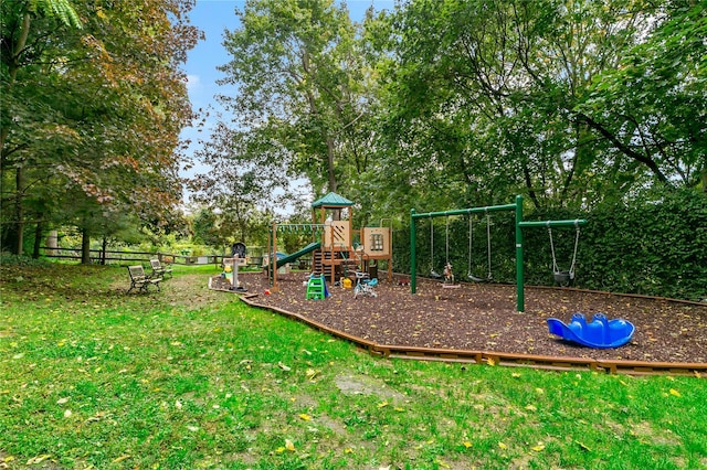 community playground with a yard and fence