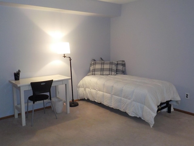 carpeted bedroom featuring baseboards