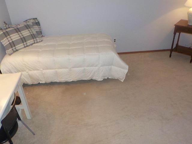 carpeted bedroom featuring baseboards