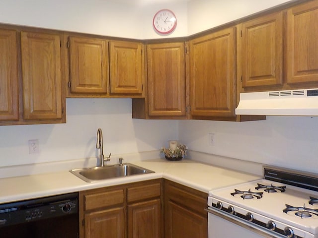 kitchen with under cabinet range hood, a sink, light countertops, dishwasher, and white gas range