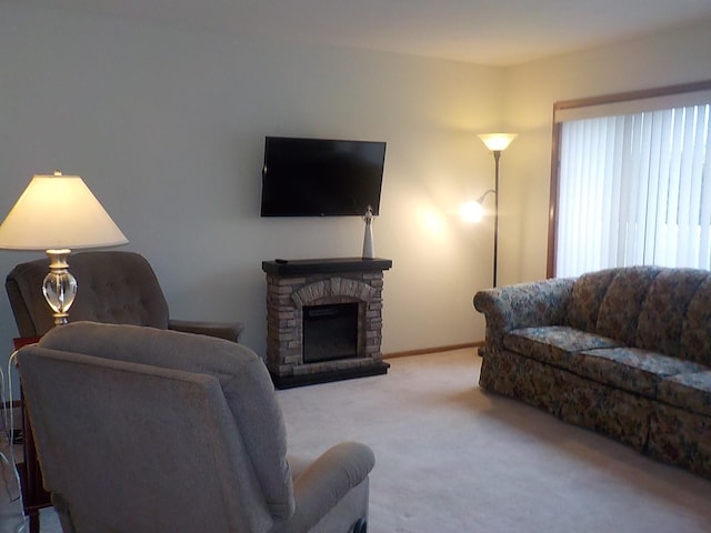 carpeted living area featuring a fireplace and baseboards