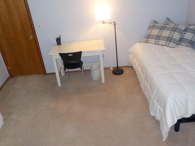 carpeted bedroom with baseboards