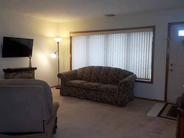 carpeted living room featuring visible vents and baseboards