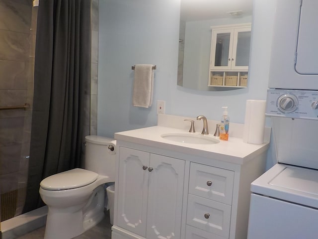 full bath featuring toilet, tiled shower, and vanity