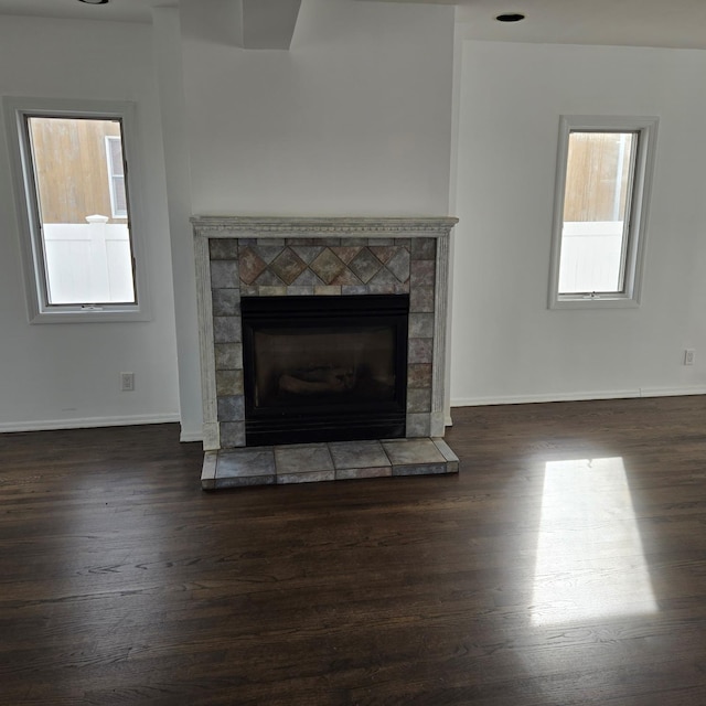 interior details with a fireplace, baseboards, and wood finished floors