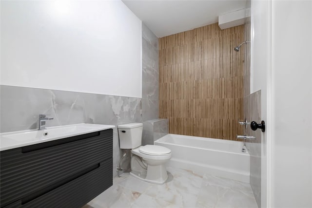 full bathroom with vanity, shower / bathing tub combination, toilet, tile walls, and marble finish floor