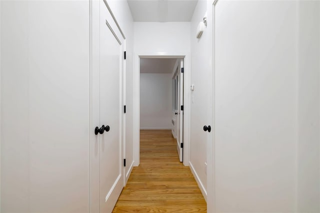 corridor featuring light wood-style flooring