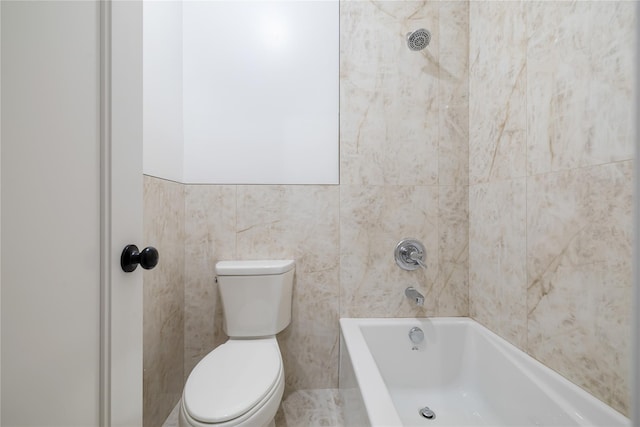 bathroom featuring toilet and tile walls