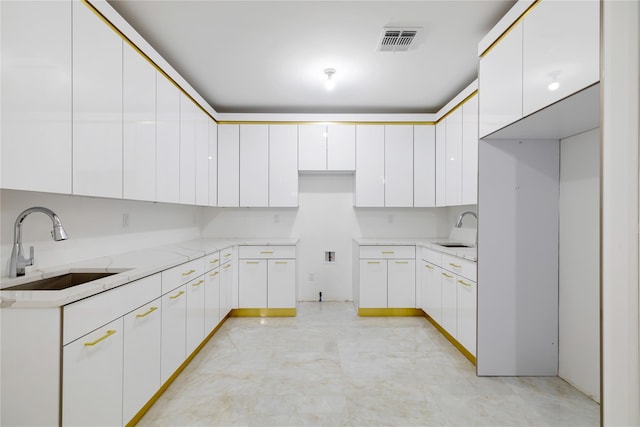 29 Calvert Dr Unit 114, Monsey, NY 10952 - kitchen featuring visible vents, light stone counters, a sink, and white cabinets