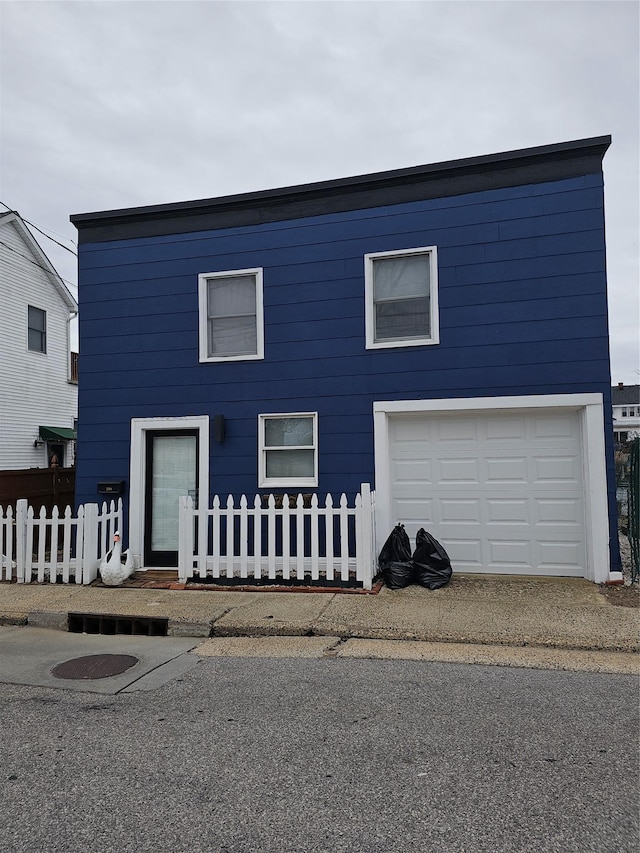 view of front of home featuring a garage and a fenced front yard