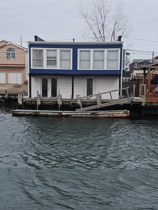 rear view of house featuring a water view