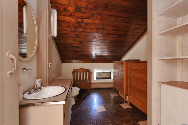 bathroom with vaulted ceiling, vanity, and toilet