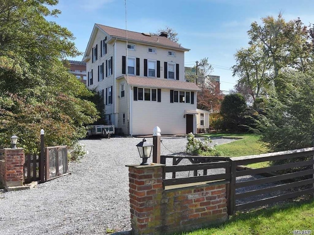 exterior space with fence and a chimney