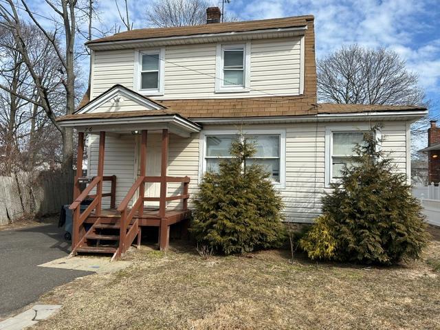 view of front of home featuring roof with shingles and a chimney