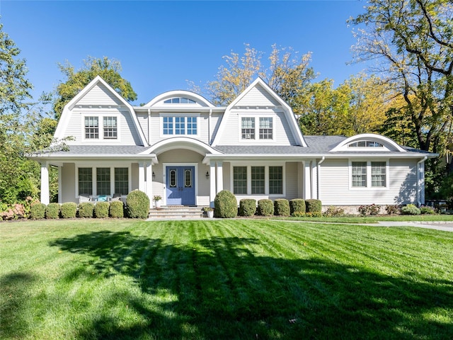 shingle-style home with french doors, roof with shingles, a front yard, and a gambrel roof