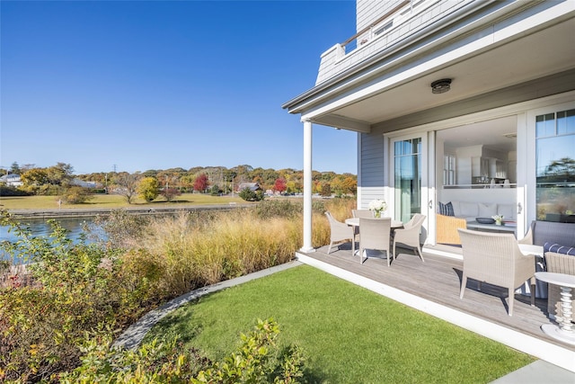 view of yard with a deck with water view