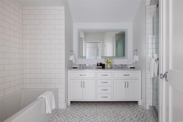 bathroom featuring double vanity, a tub, a shower, and a sink