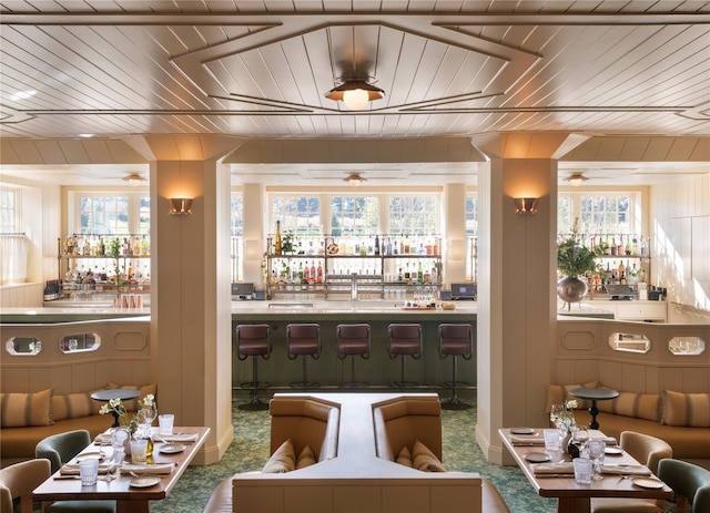 bar with carpet flooring, wood ceiling, and wet bar