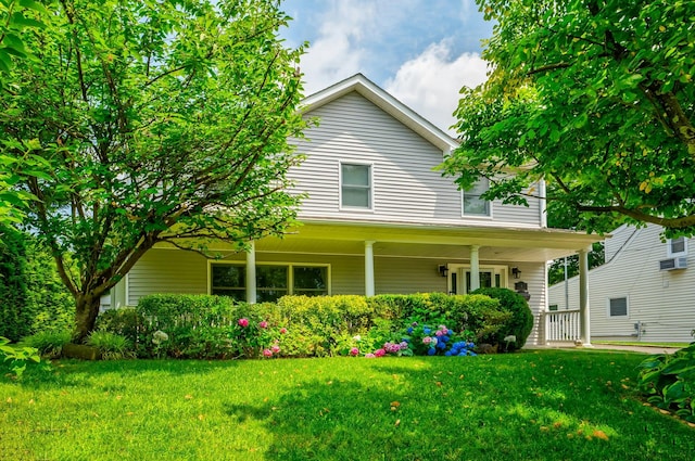 view of front of home with a porch and a front lawn