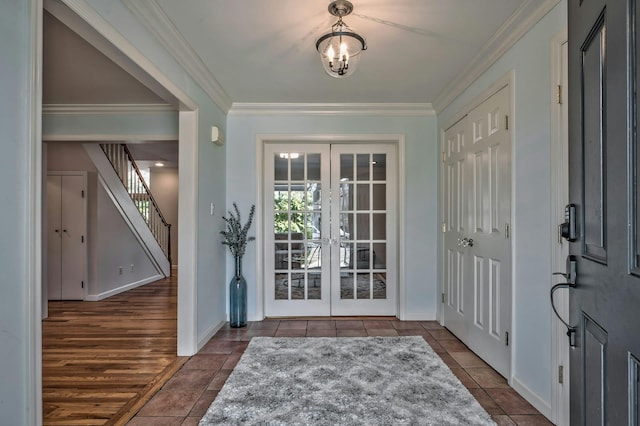 entrance foyer featuring tile patterned flooring, crown molding, stairs, and french doors