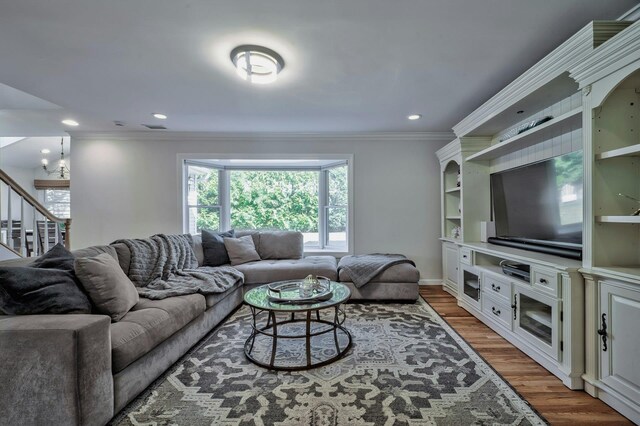 living room featuring recessed lighting, crown molding, and wood finished floors