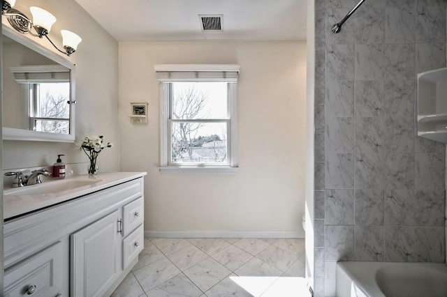 bathroom with visible vents, baseboards, shower / bathing tub combination, marble finish floor, and vanity