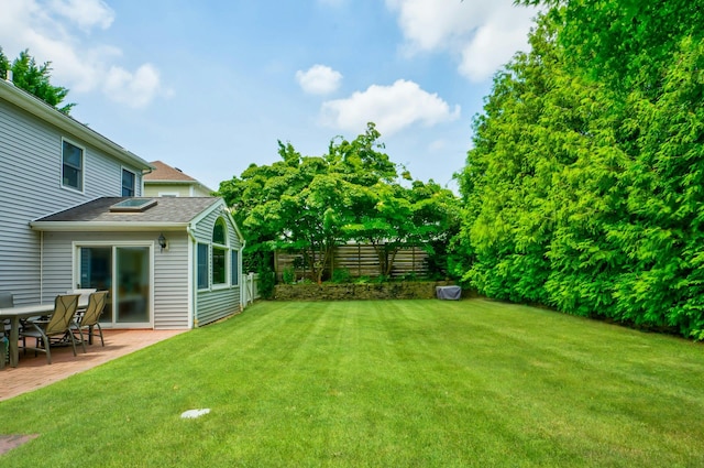 view of yard with a patio and fence