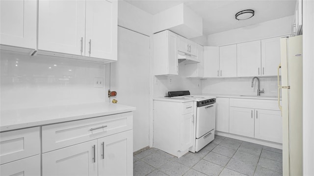 kitchen with light countertops, white cabinets, a sink, white appliances, and under cabinet range hood