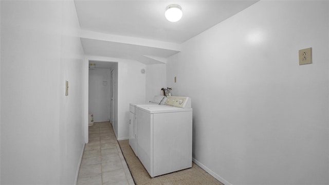 laundry area with baseboards, laundry area, and washer and dryer