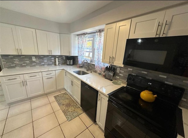 kitchen featuring black appliances, light tile patterned floors, white cabinetry, and a sink