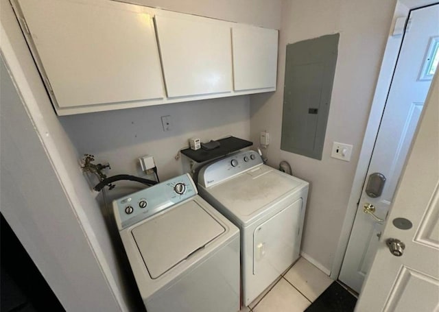 clothes washing area with cabinet space, electric panel, baseboards, washer and dryer, and light tile patterned flooring