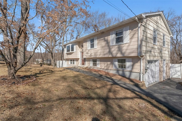 back of property featuring a garage and driveway