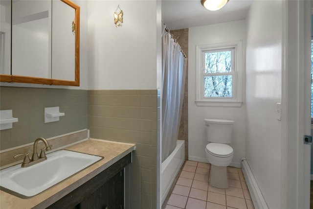 bathroom featuring tile patterned flooring, tile walls, a baseboard heating unit, toilet, and vanity