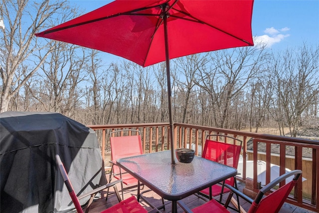 wooden deck featuring grilling area and outdoor dining area